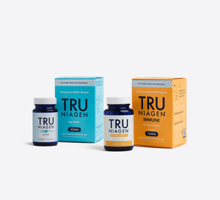 Two blue bottles with white labels, one labeled TRU NIAGEN IMMUNE and the other TRU NIAGEN 300mg with the carton packaging the bottles come in.